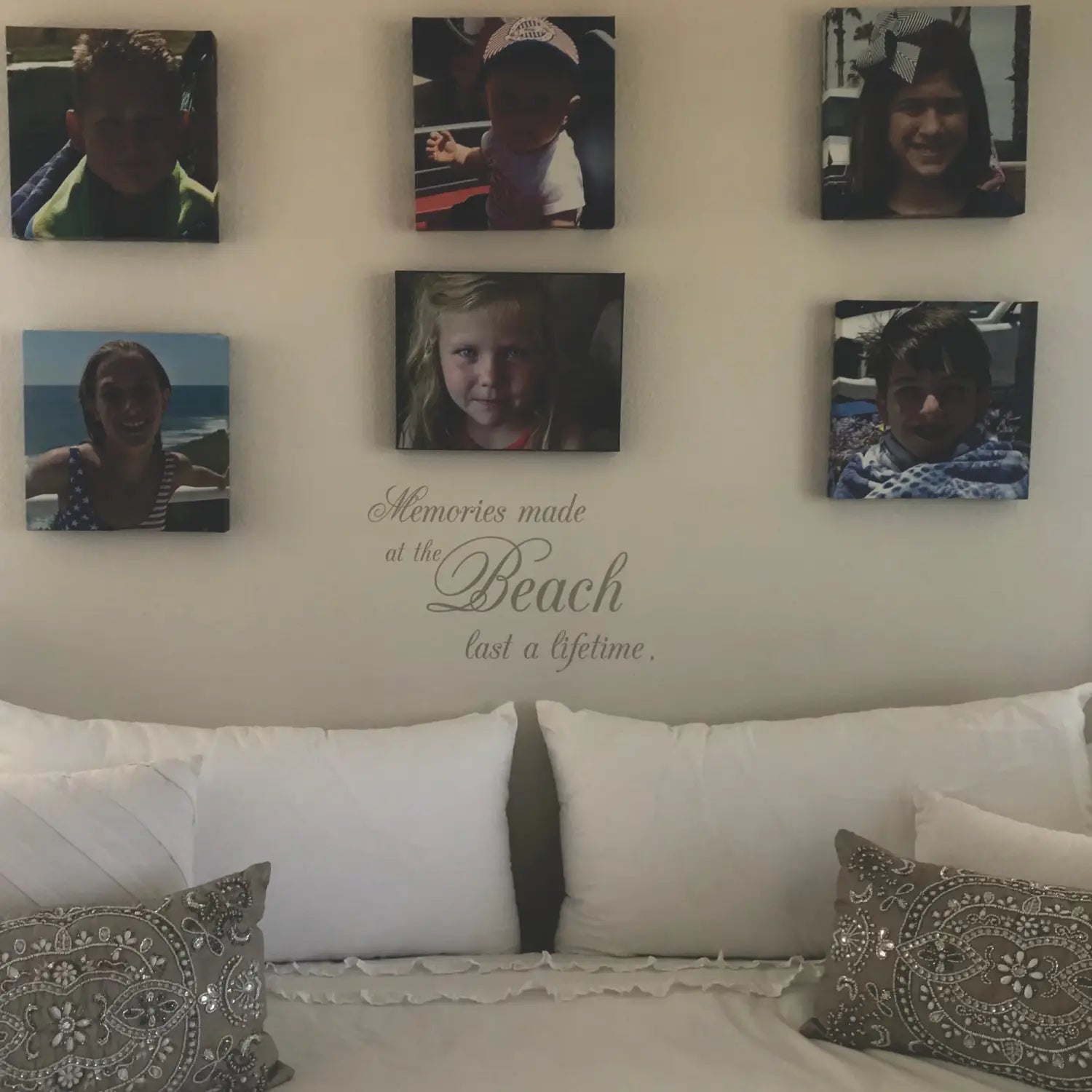 A beautiful wall decal display of a family photo wall display showing a Simple Stencil quote that reads: Memories made at the beach last a lifetime... and is surrounded by beautiful photos of her family beach vacation.