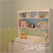Easy peel and stick wall decals help separate two wall colors to soften and cover imperfections. By The Simple Stencil