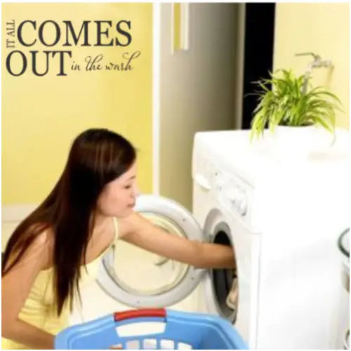 A cute vinyl wall decal for your laundry room walls that reads: It all comes out in the wash.