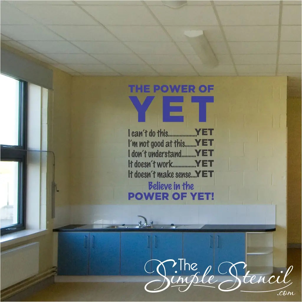 A two color Power of Yet vinyl wall decal applied to an empty classroom wall to encourage and motivate students to keep believing in themselves.