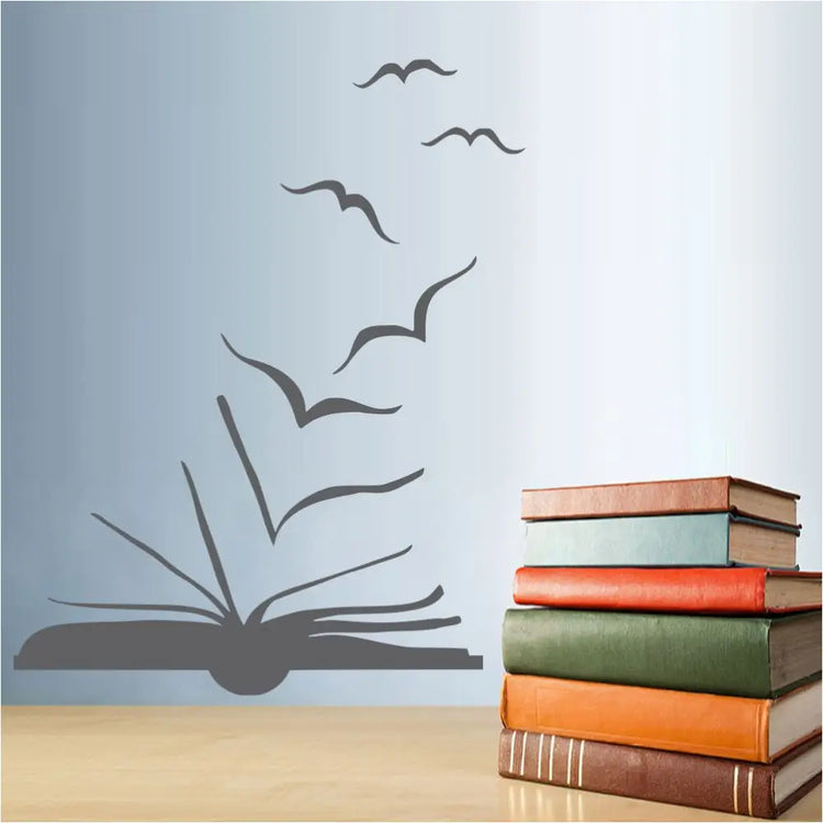 A library wall decal silhouette art of a book pages turning into flying birds. This is a nice decoration for a school or library wall to encourage reading.