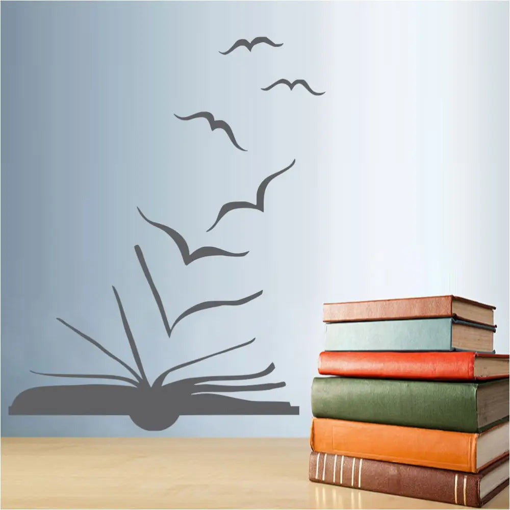 A library wall decal silhouette art of a book pages turning into flying birds. This is a nice decoration for a school or library wall to encourage reading.