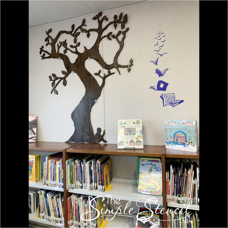 A vibrant and whimsical vinyl wall decal adorns the wall of an elementary school library, depicting a collection of open books soaring through the air amidst a backdrop of pastel hues. The diverse array of books symbolizes the boundless imagination and limitless possibilities that await young minds within the library's walls.