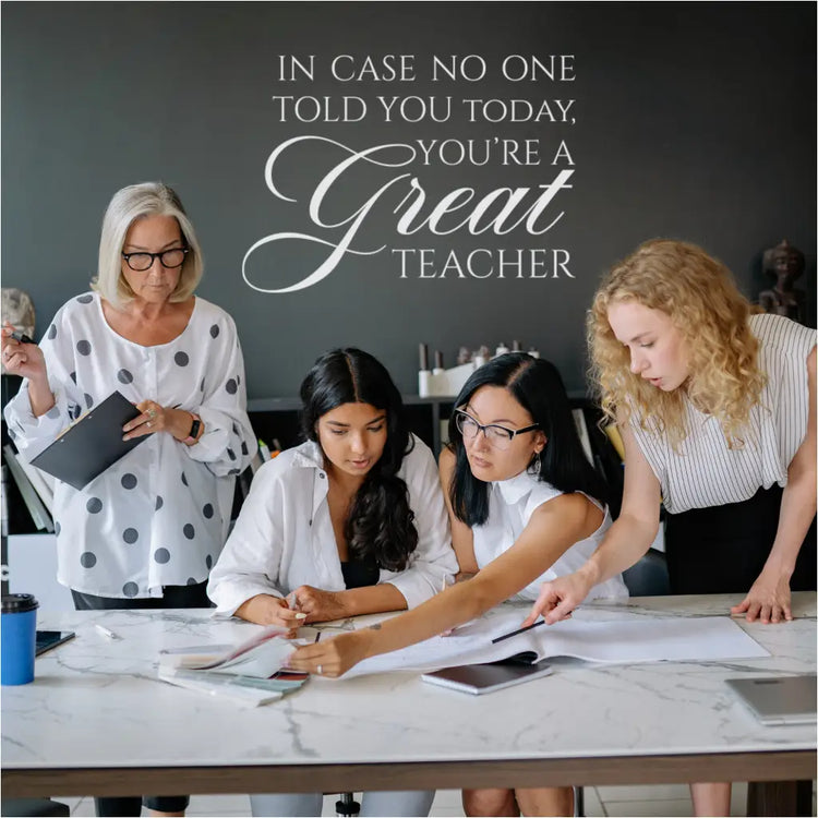 The "In case no one has told you today, you're a GREAT teacher" wall decal displayed in a teacher's lounge.