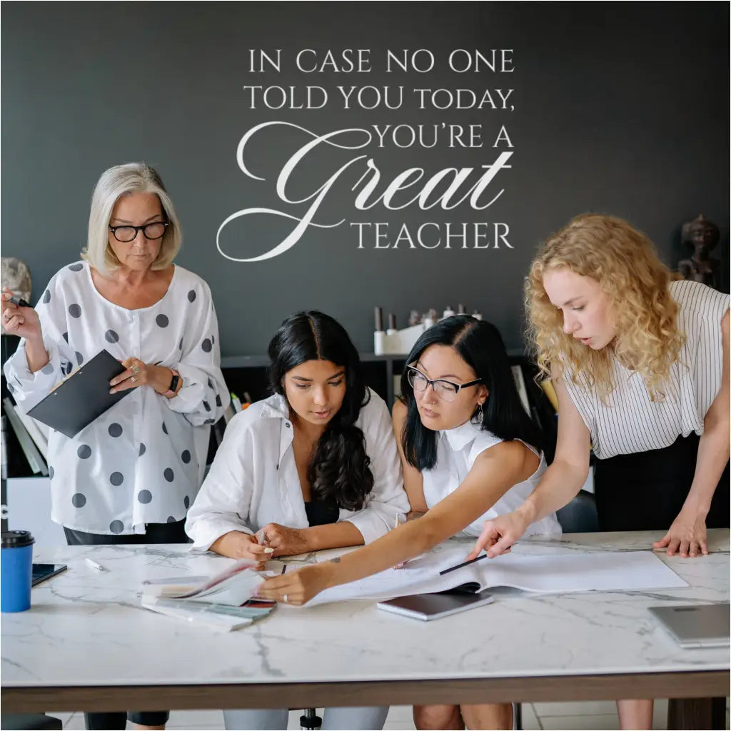 The "In case no one has told you today, you're a GREAT teacher" wall decal displayed in a teacher's lounge.