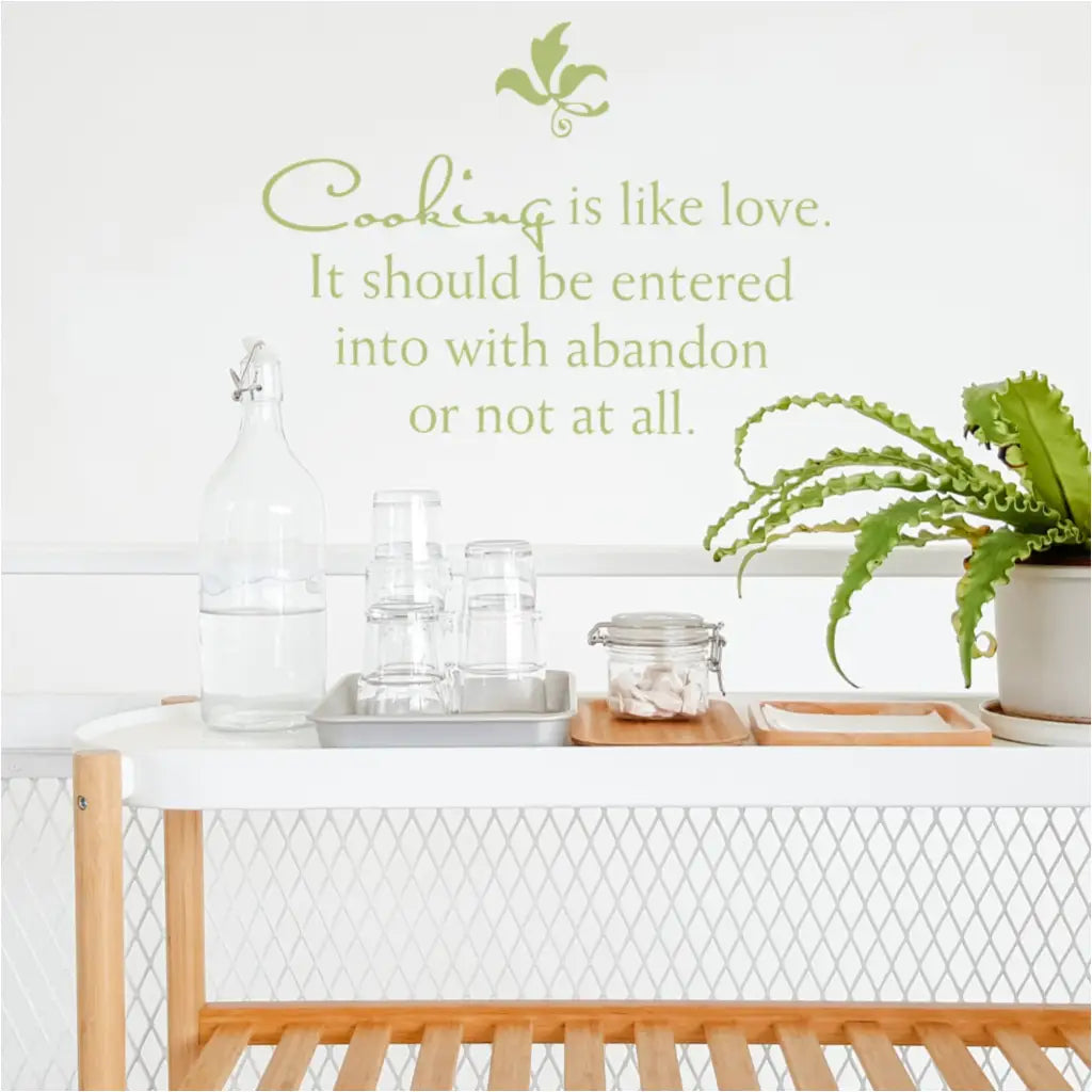 Cute wall quote decal on kitchen wall that reads: Cooking is like love. It should be entered into with abandon or not at all.