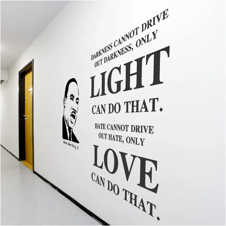 Large Black History Month wall display on school hallways using a silhouette of MLK alongside his inspiring wall quote that reads: Darkness cannot drive out darkness, only light can do that. Hate cannot drive out hate, only love can do that. 