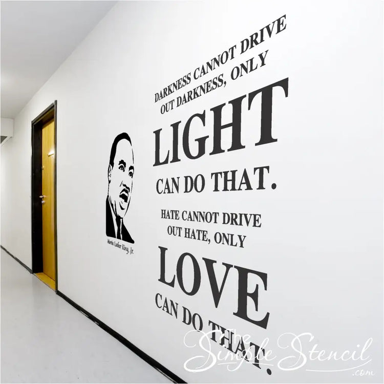 Large Black History Month wall display on school hallways using a silhouette of MLK alongside his inspiring wall quote that reads: Darkness cannot drive out darkness, only light can do that. Hate cannot drive out hate, only love can do that.