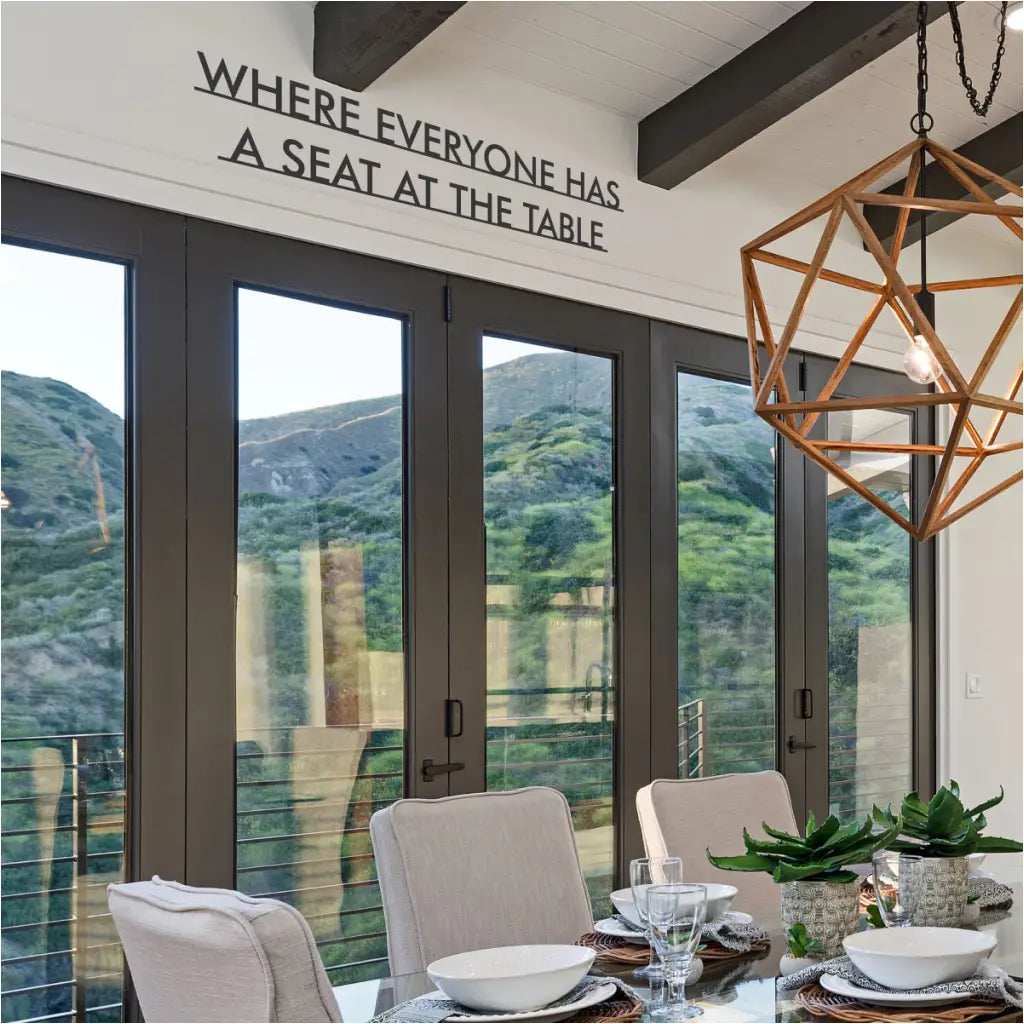 Modern vinyl wall decal for dining room decorating with the phrase "Where everyone has a seat at the table"