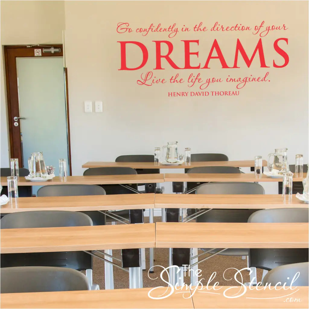 Inspirational "Go confidently in the direction of your dreams" wall quote by Thoreau displayed in Red on a large wall