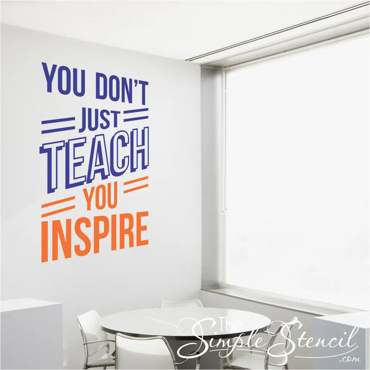 "You Don't Just Teach, You Inspire" wall decal in blue and orange on a teacher's lounge wall.