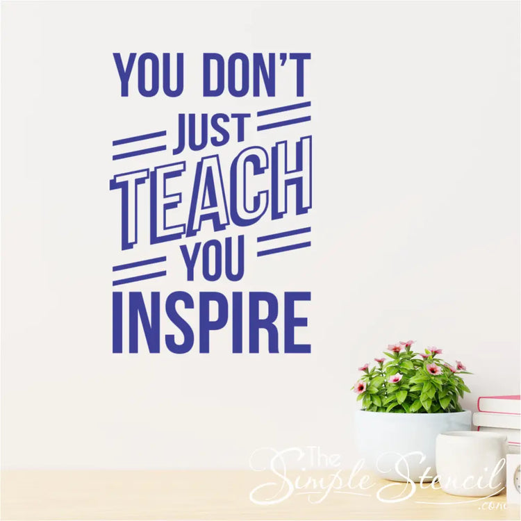 The "You Don't Just Teach, You Inspire" wall decal applied above a teacher's desk.
