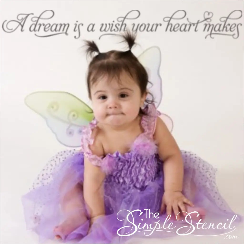 A dream is a wish your heart makes wall decal display over a picture of baby dressed up for halloween.