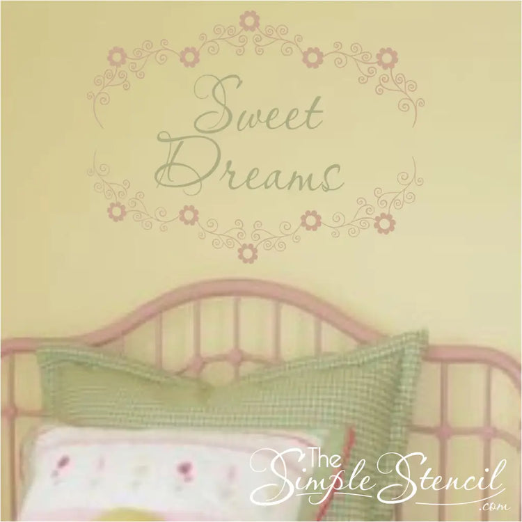 Custom floral name decal with "Sweet Dreams" text, used as a decorative accent above a bed.