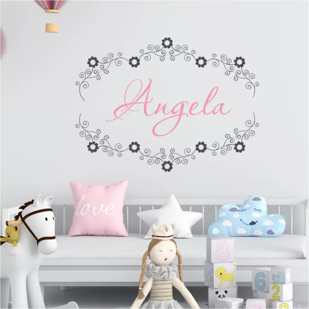 Flower Frame Custom floral name wall decal featuring "Angela" encircled by swirly vines and flowers in a nursery.