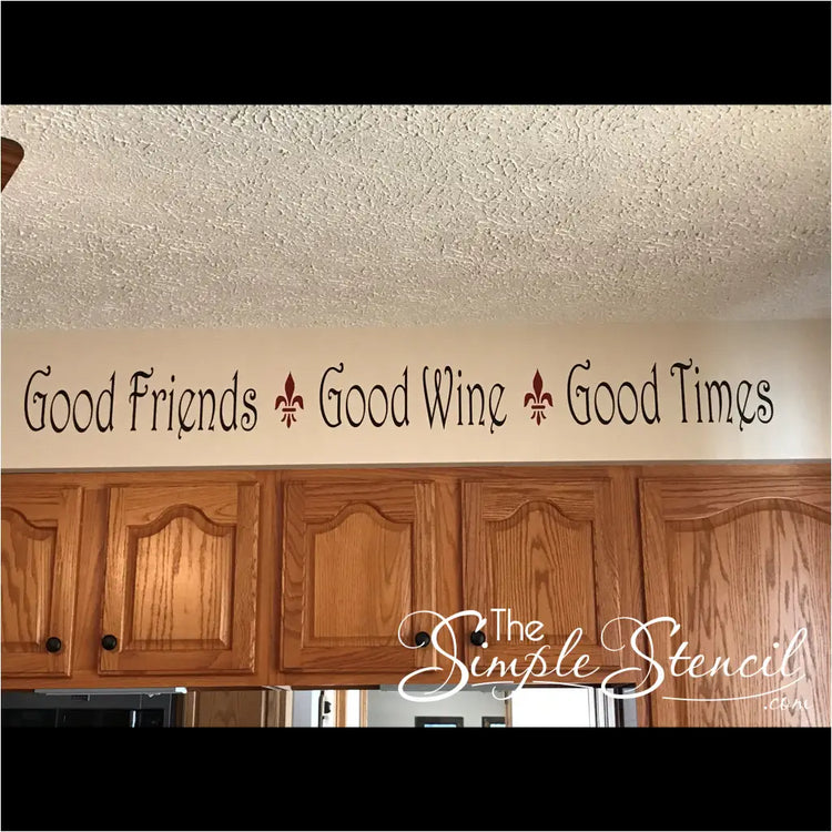 customer supplied picture of their wall decal by The Simple Stencil on their kitchen soffit reads: Good friends, Good wine, Good times. 