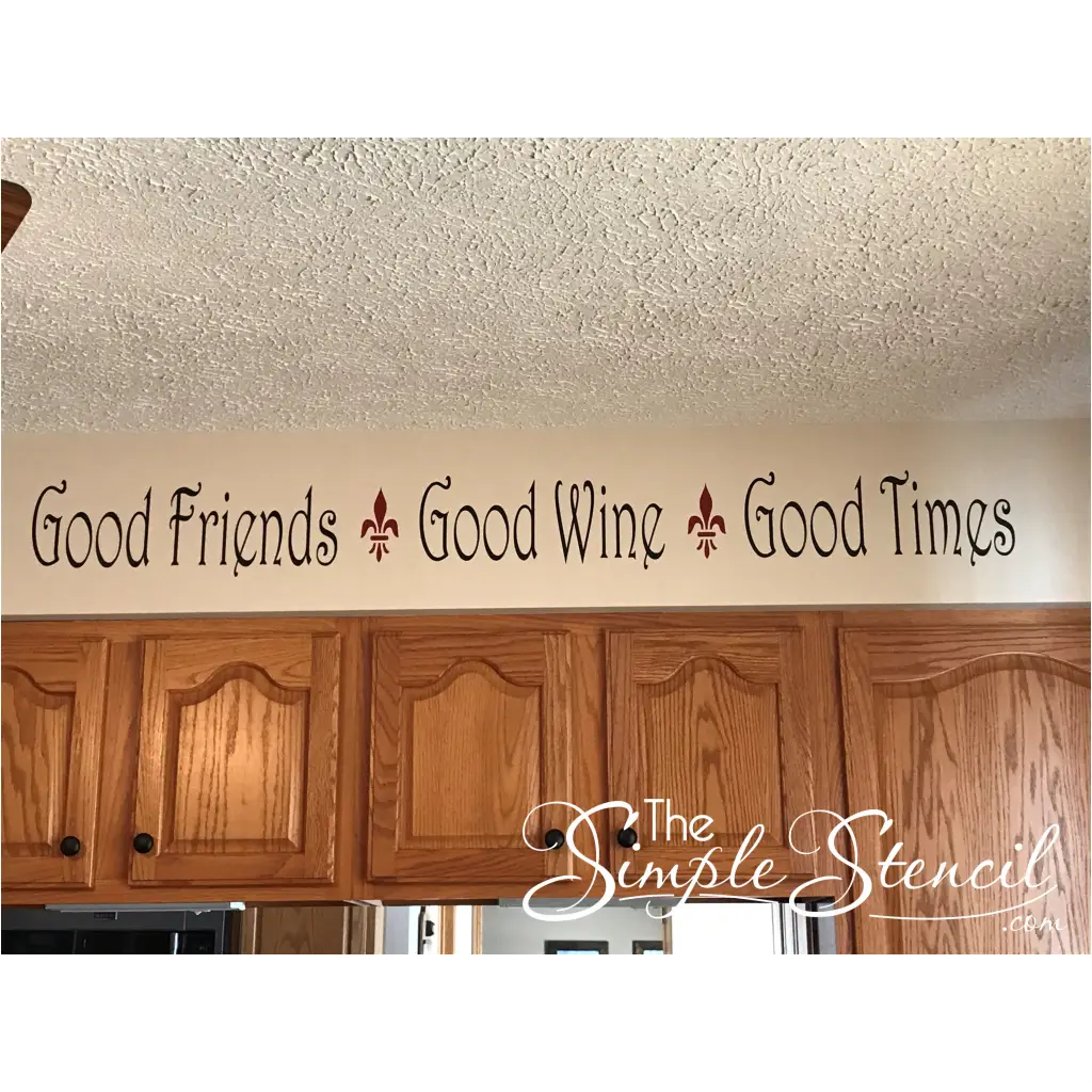 customer supplied picture of their wall decal by The Simple Stencil on their kitchen soffit reads: Good friends, Good wine, Good times.