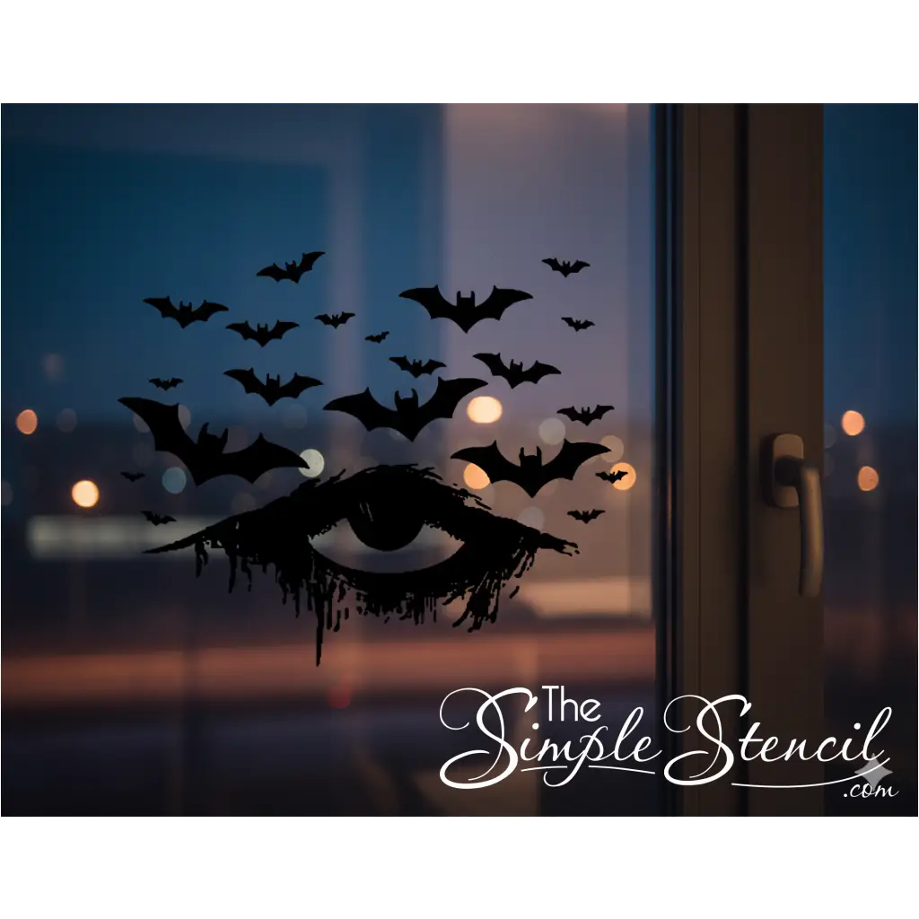 A black vinyl Halloween decal of a distressed, dripping eye with numerous bats flying above it, applied to a window at dusk. Blurred city lights are visible in the background, creating a moody and atmospheric gothic Halloween scene.