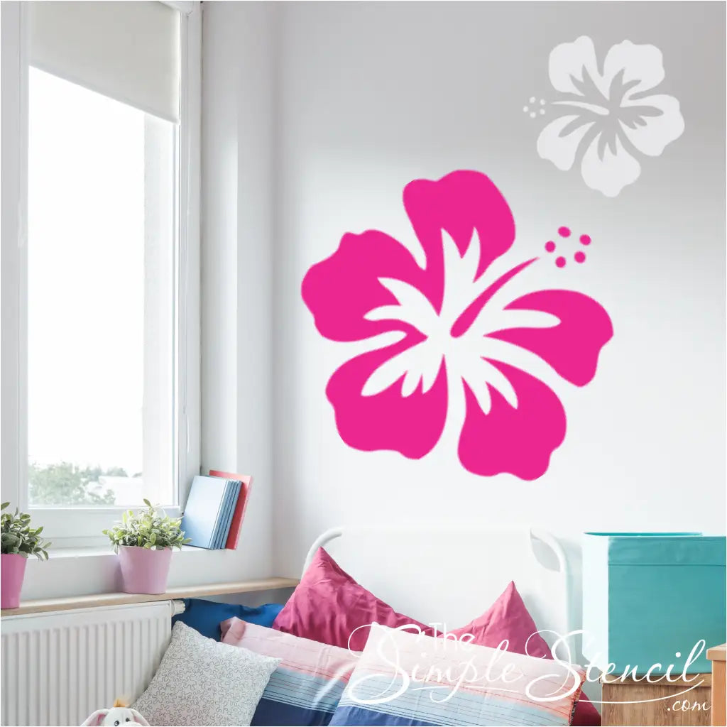 Arrangement of multiple hibiscus flower decals in different sizes and colors on a large wall, creating a summer-themed display.