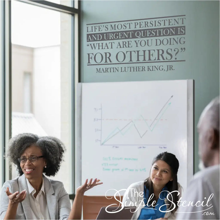 A group of volunteers gathered around the MLK quote decal, discussing service opportunities and brainstorming new initiatives. Wall Decal by TheSimpleStencil.com