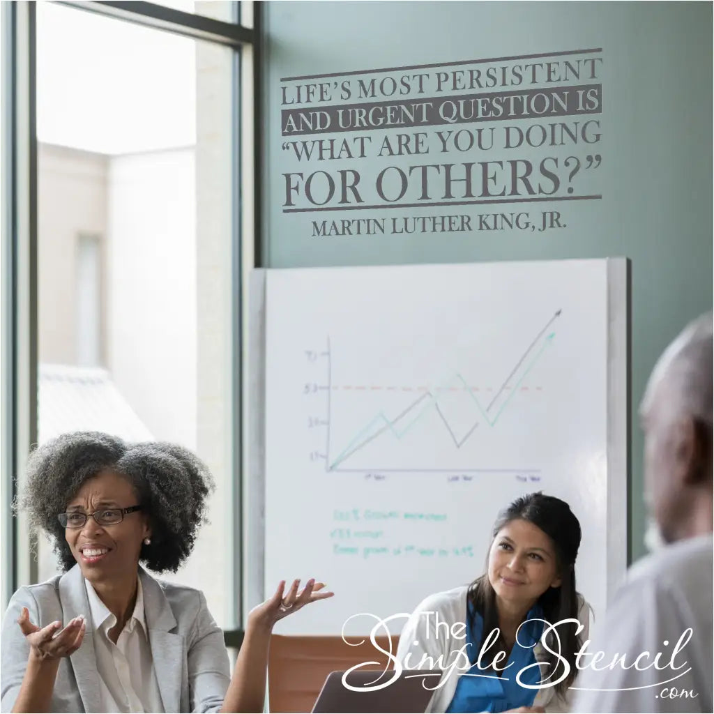 A group of volunteers gathered around the MLK quote decal, discussing service opportunities and brainstorming new initiatives. Wall Decal by TheSimpleStencil.com