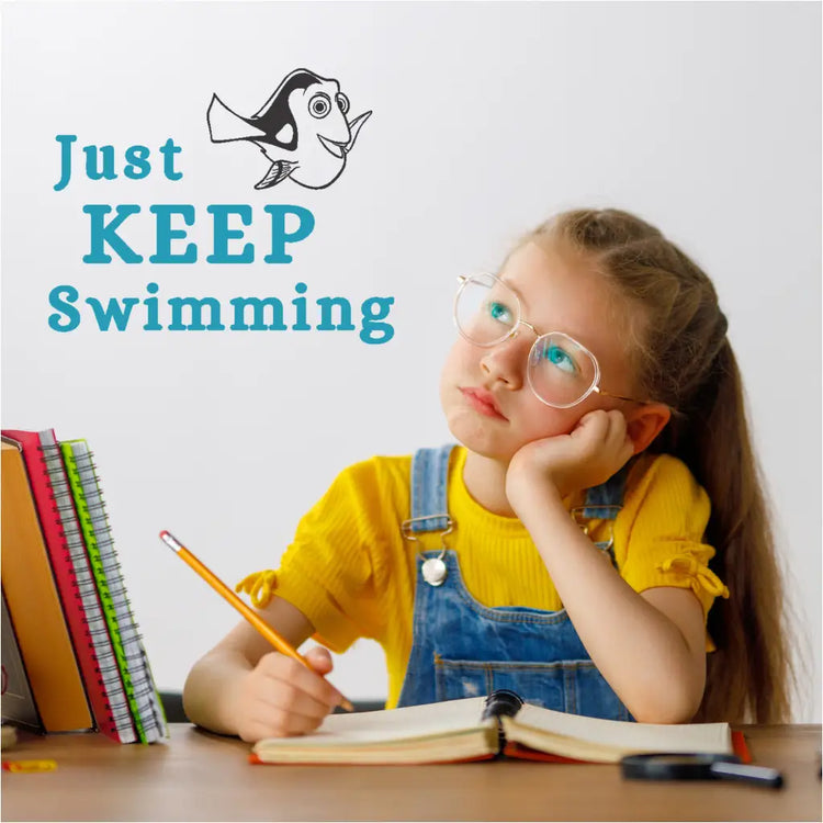 "Just Keep Swimming" wall decal applied on a classroom wall with student in thought.