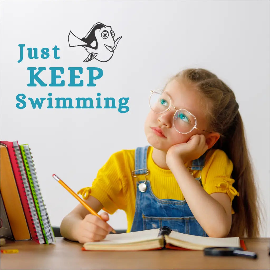 "Just Keep Swimming" wall decal applied on a classroom wall with student in thought.