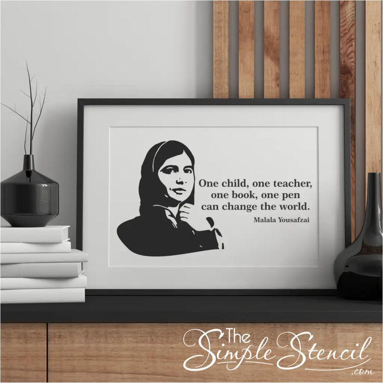 Framed Malala Yousafzai poster print in an office: A framed Malala Yousafzai poster print hanging in a modern office, promoting a culture of equality.