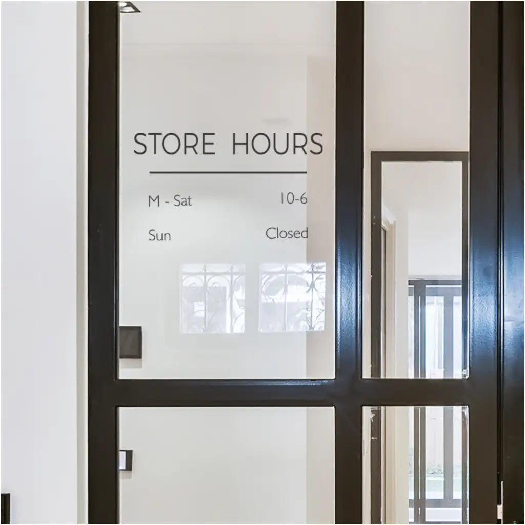 Modern and Minimalist Store Hours decal personalized with customers hours displayed on modern storefront glass window with DIY install
