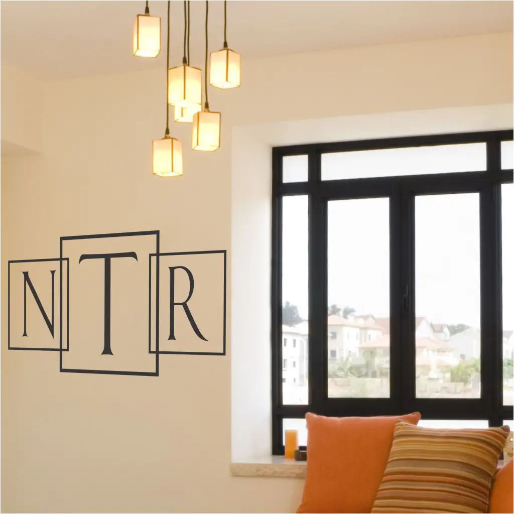 Single initial with box outline modern wall or window monogram applied to a wall in a creative way by using three different decals to spell out all three initials in name with the middle initial being larger in the center. Wow, this Simple Stencil customer did great!