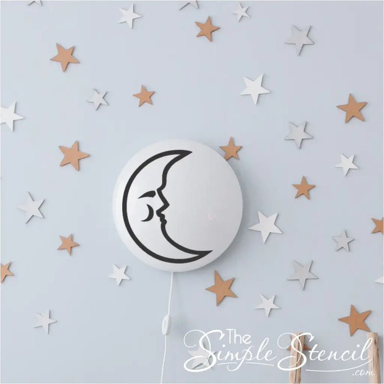 Sleepy moon decal applied to smooth plastic wall light to create custom diy baby nursery decor