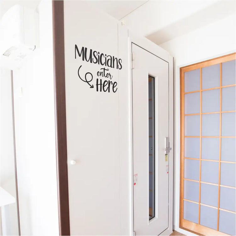 Colorful "Musicians Enter Here" vinyl decal adorns the entrance of a music studio, guiding musicians with a playful touch and adding a personalized flair to the creative workspace.