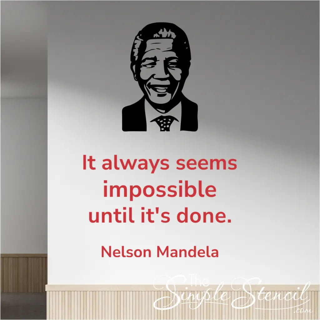 Red Nelson Mandela quote "It always seems impossible until it's done" wall decal in Modern font, placed next to a black silhouette image decal of Nelson Mandela, on a light-colored office hallway wall.