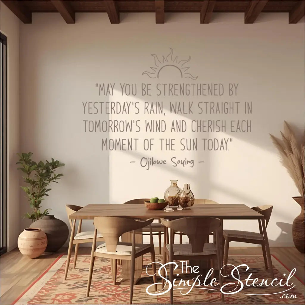 The Ojibwe saying wall decal in a Southwestern-style dining room featuring a patterned rug, exposed beams, and terracotta pots.