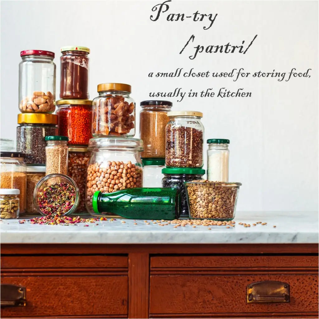 Pantry definition wall decal by The Simple Stencil shown on a wall over a pantry countertop with an assortment of jarred goods.