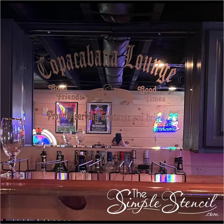 A personalized mirror decal adds a touch of whimsy and camaraderie to a home bar, proudly proclaiming the establishment's name, "Cococabana Lounge," as a haven for good friends and good times. The decal's jovial message, "Proudly serving whatever you bring!" sets a welcoming tone, inviting guests to bring their favorite beverages and enjoy the company of fellow revelers. Customize yours at The Simple Stencil