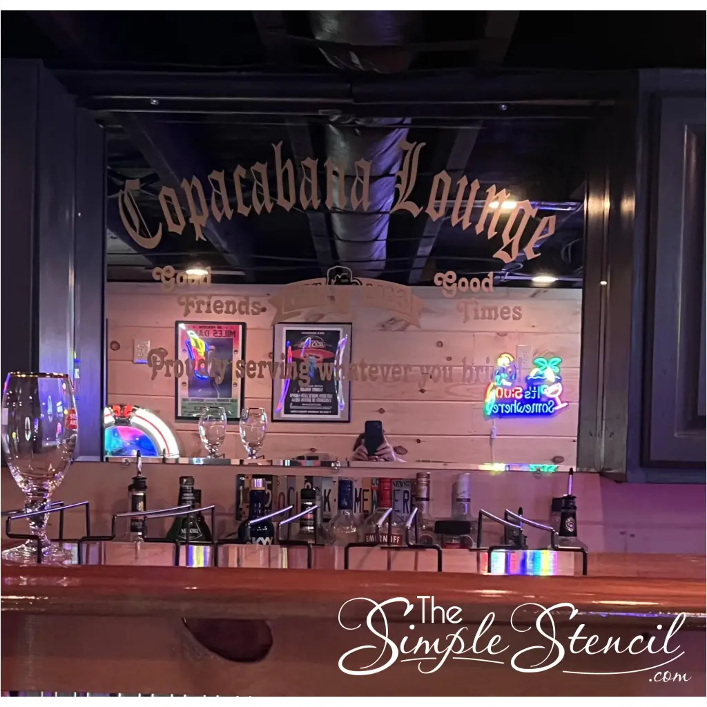 A personalized mirror decal adds a touch of whimsy and camaraderie to a home bar, proudly proclaiming the establishment's name, "Cococabana Lounge," as a haven for good friends and good times. The decal's jovial message, "Proudly serving whatever you bring!" sets a welcoming tone, inviting guests to bring their favorite beverages and enjoy the company of fellow revelers. Customize yours at The Simple Stencil