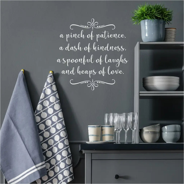 A pretty kitchen wall with a sweet Simple Stencil wall decal display that reads: A pinch of patience, a dash of kindness, a spoonful of laughs and heaps of love.