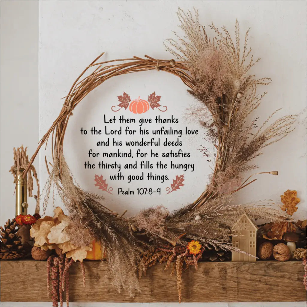 The Psalm 107:8-9 "Let them give thanks" wall decal is displayed inside a rustic grapevine wreath on a wooden fireplace mantel, surrounded by fall foliage and pinecones.
