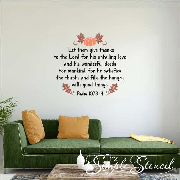 The Psalm 107 bible verse decal, featuring a pumpkin graphic, is shown on a living room wall above a modern green sofa with mustard yellow pillows.