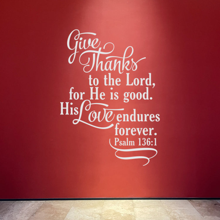 "His Love Endures Forever" decal in bright white, creating a powerful, high-contrast focal point on a vibrant red accent wall.