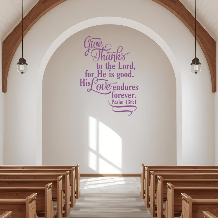 Large Psalm 136:1 religious wall stencil in light purple, applied to a white archway above pews in a bright, modern church sanctuary.