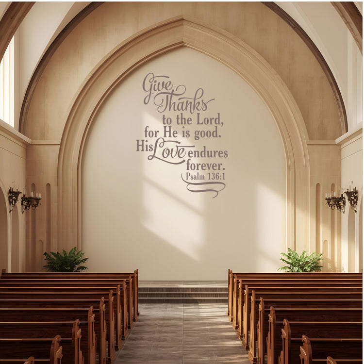 Church wall décor vinyl lettering of the Bible verse "Give thanks to the Lord" on a large, stone-colored arched wall above the altar/pulpit area.