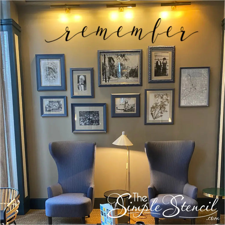 a beautiful family picture wall over a sitting area with the wall decal that reads simply remember to highlight their ancestors memories.