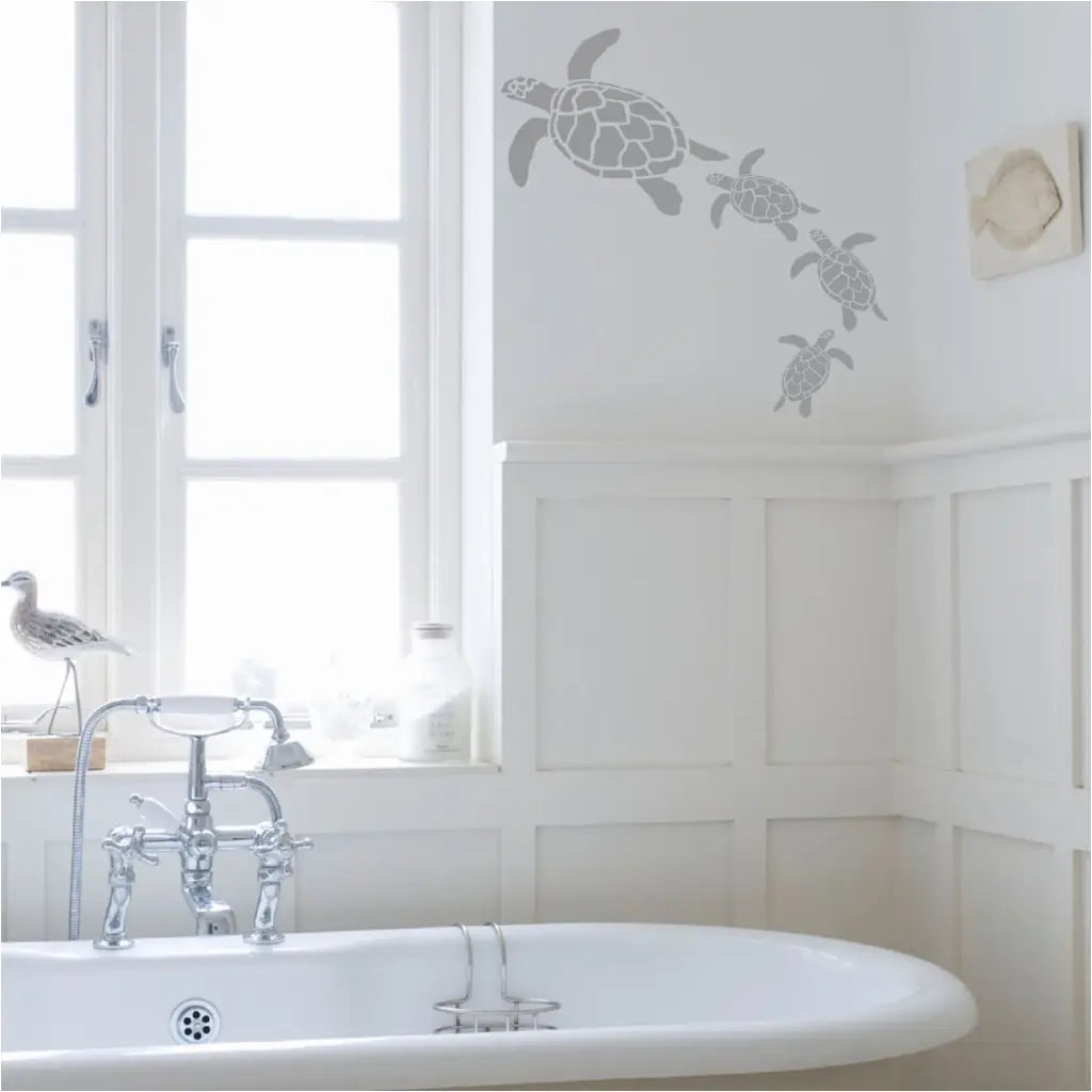 Sea turtle wall decal art by The Simple Stencil applied to a beautiful bathroom wall with other nautical decor.