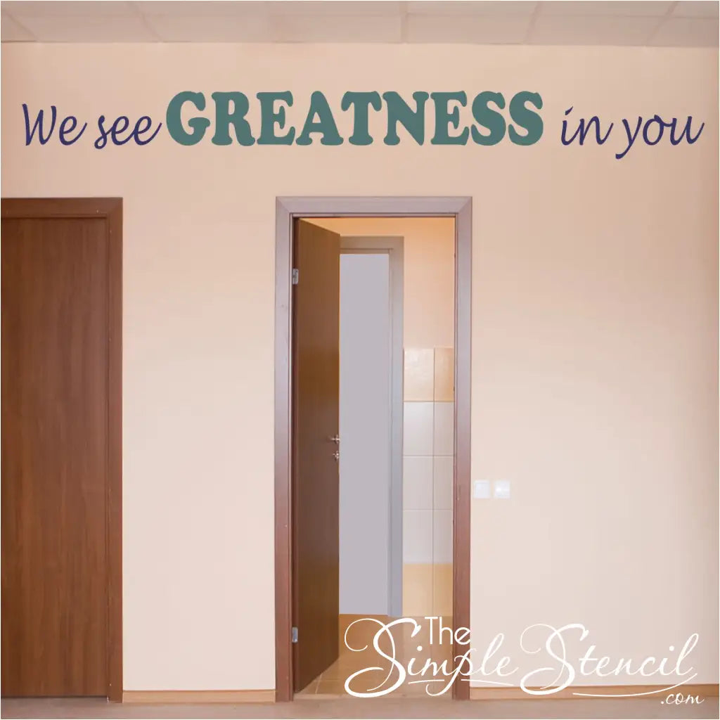 We see greatness in you. A large vinyl wall decal sign over a school classroom doorway.