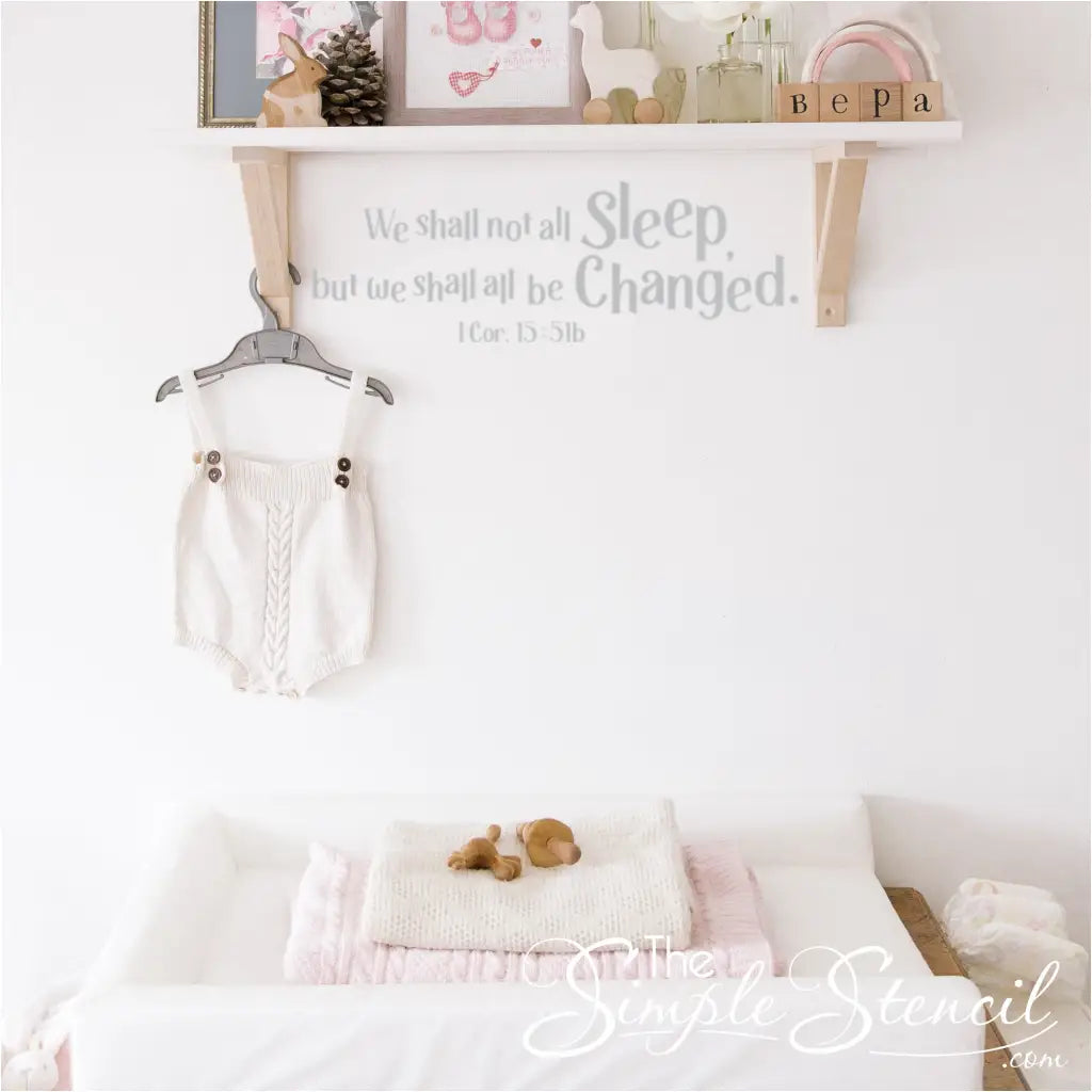 A whimsical take on scripture, the "We shall not all sleep, but we shall all be changed" decal adds a touch of humor to a baby's changing area.