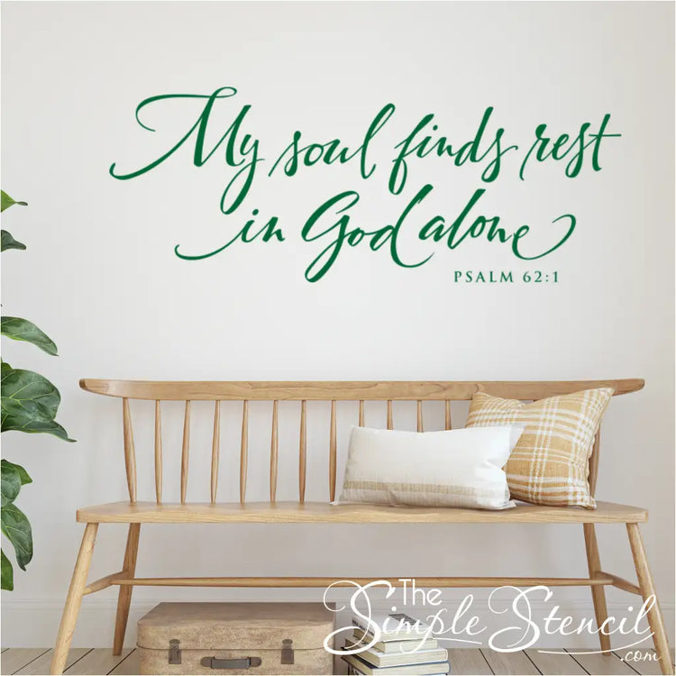 Christian home decor using green scripture wall decal above a wooden bench and pillows.