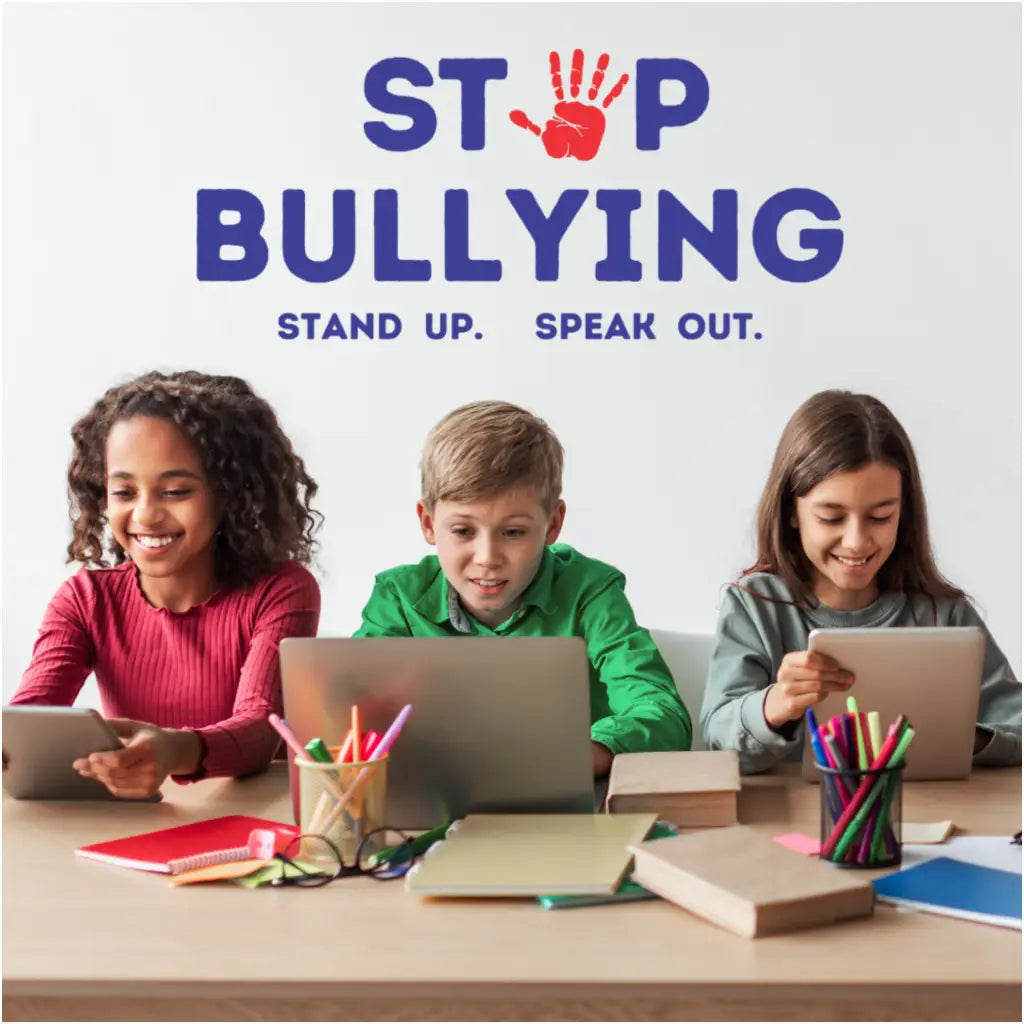 A high quality school wall decal that reads STOP BULLYING STAND UP. SPEAK OUT.  to help promote kindness and discourage bullying in your school and learning environments. Shown next to students working together and can be found for purchase at TheSimpleStencil.com