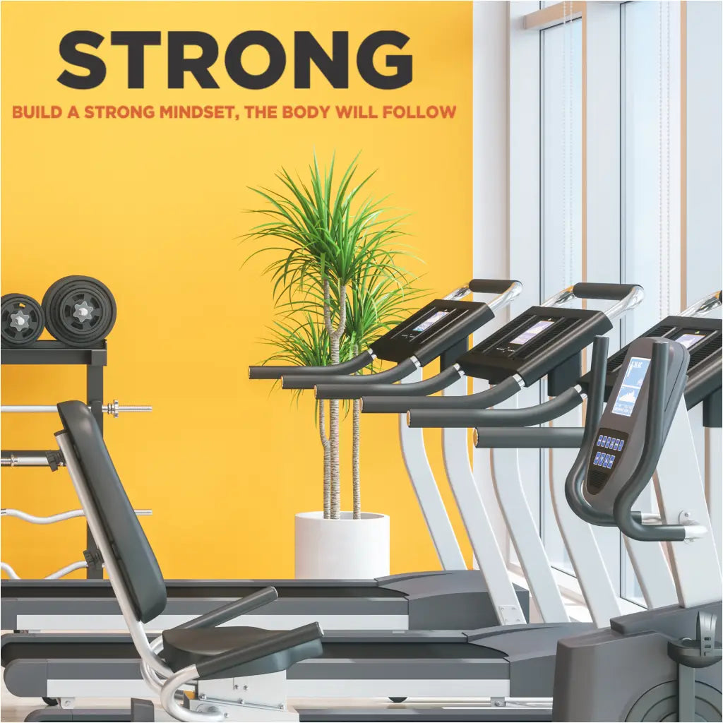 A large vinyl wall decal by The Simple Stencil for a fitness center gym wall that reads STRONG - build a strong mindset, the body will follow.